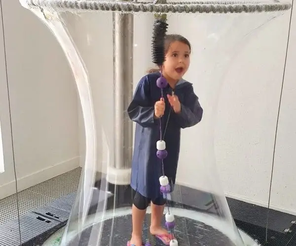 Bubble Monster exhibit raising a giant soap bubble around a visitor