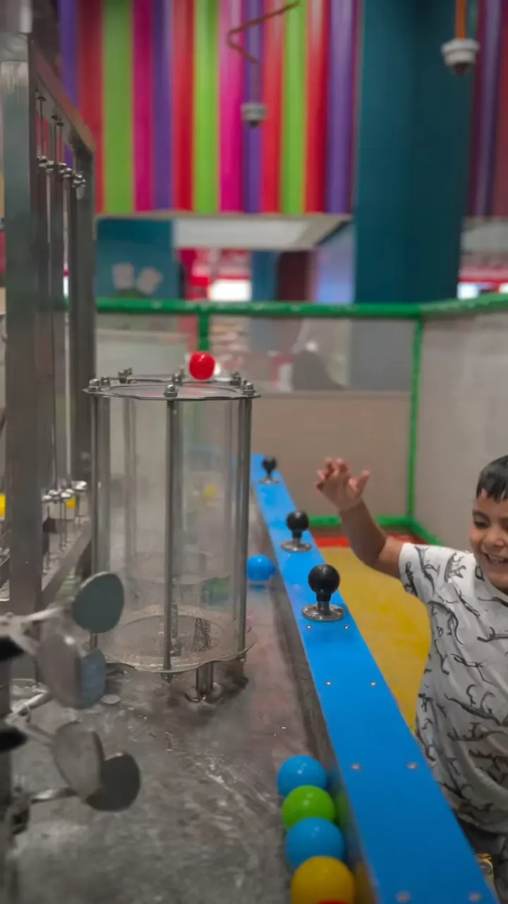 Child playing with floating balls at the compact water table