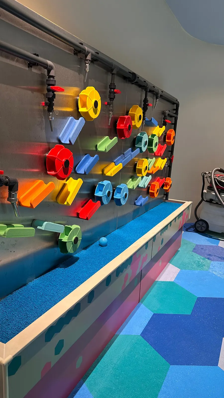 Visitors guiding water down the Magnetic Water Wall