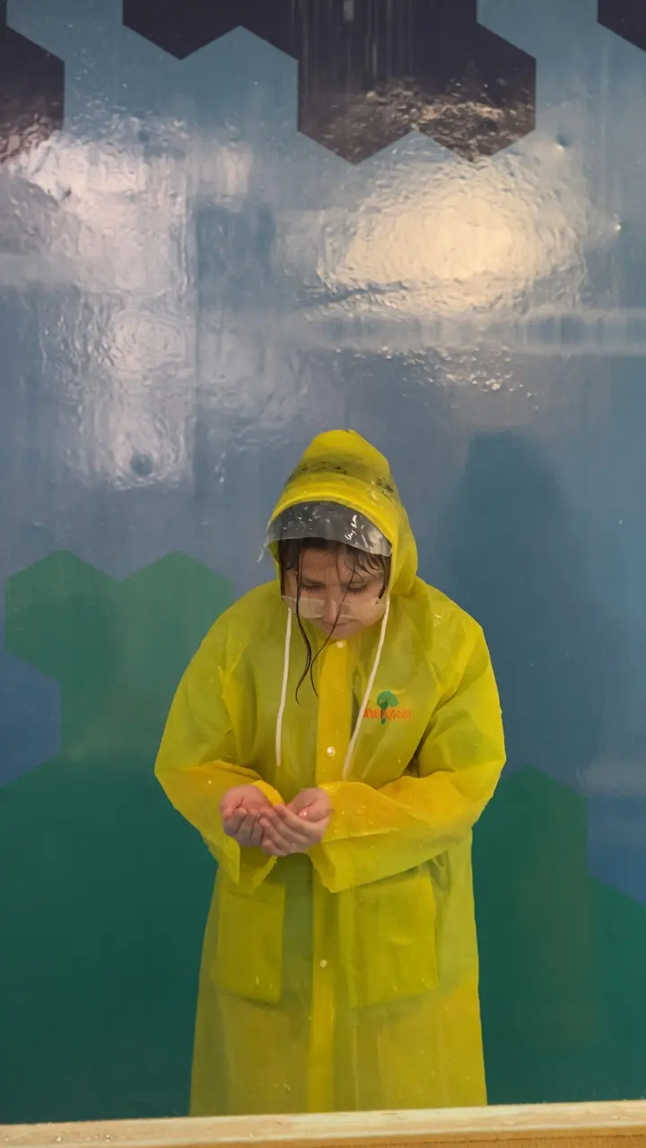 Child triggering the rain at the Raining Clouds exhibit