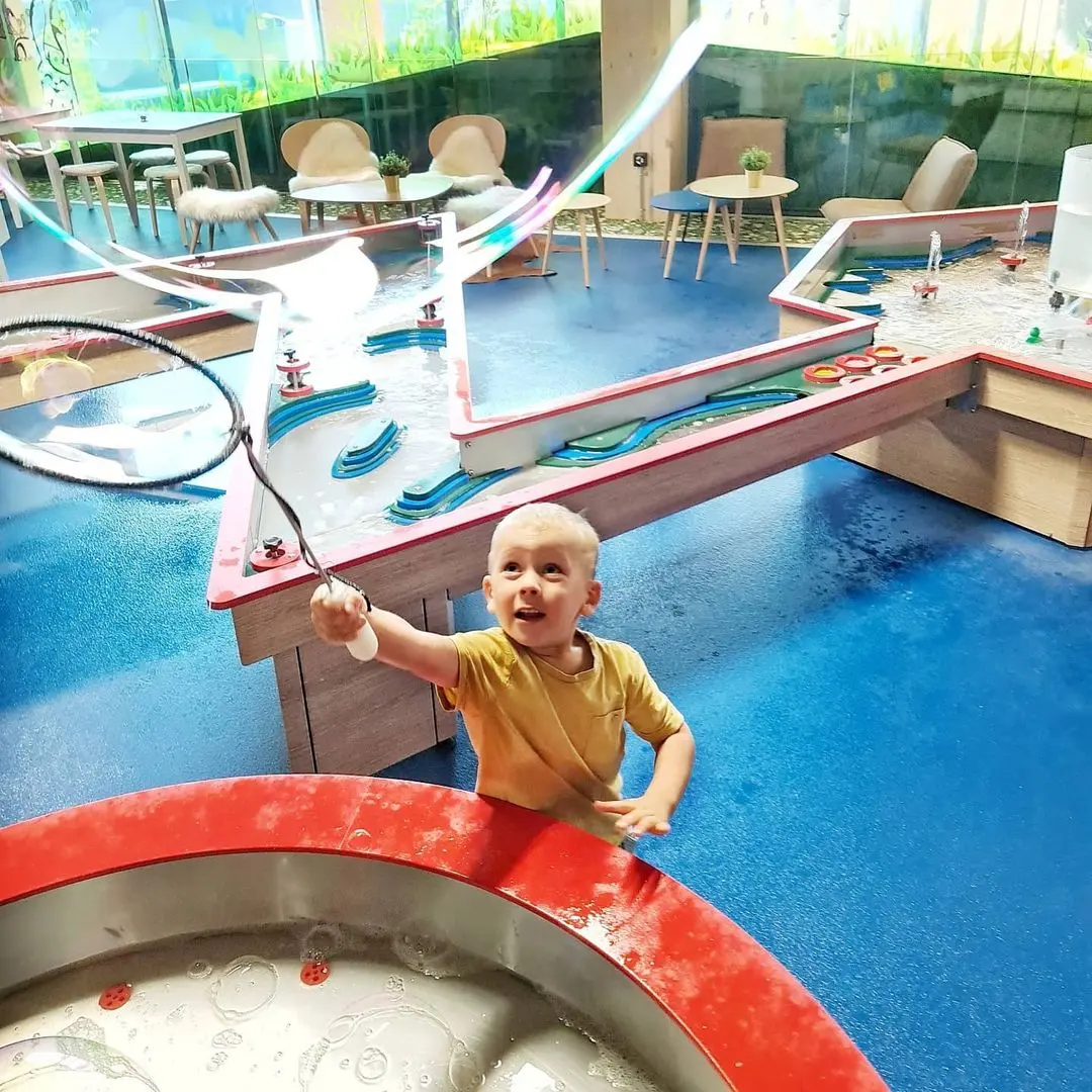 Visitors making bubbles at the soap basin