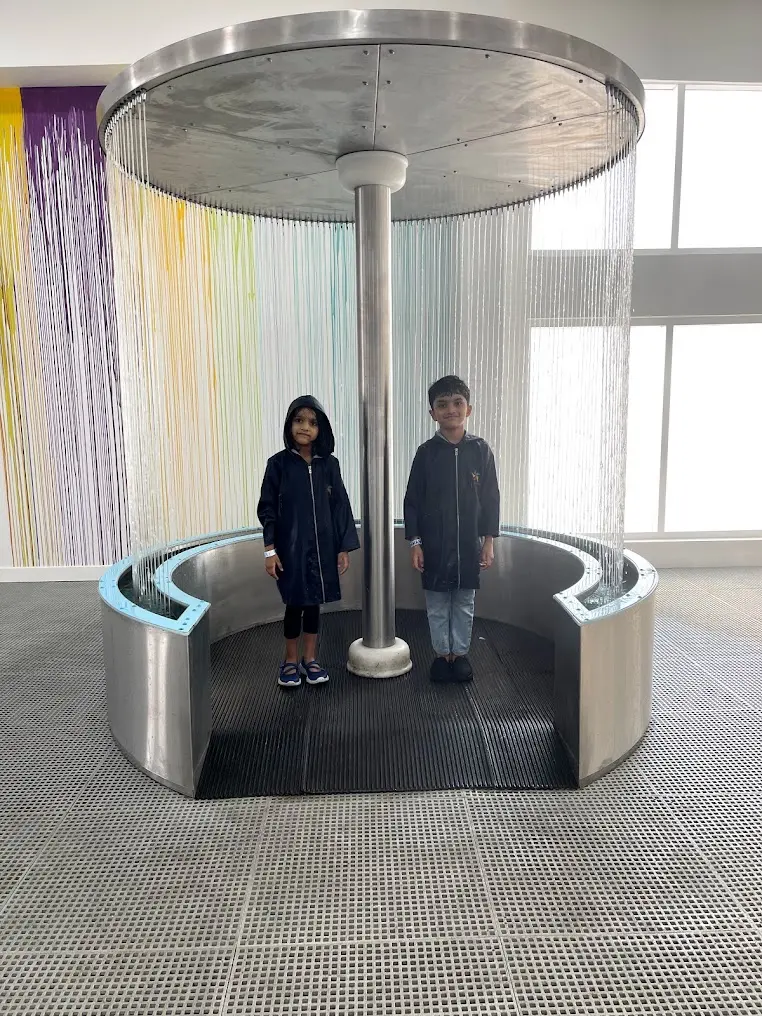 Visitor stepping inside the circular Water Curtain