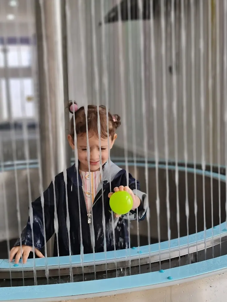 Children playing at the Water Curtain exhibit
