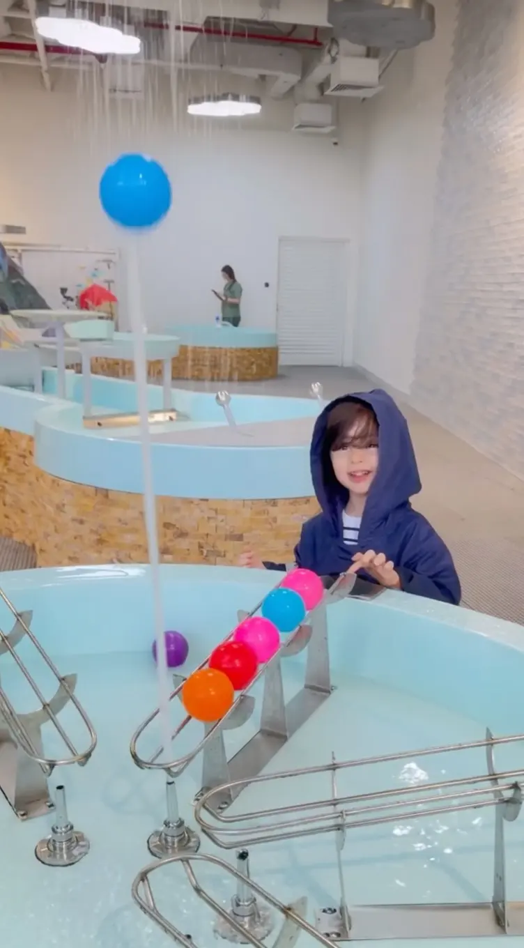Visitors playing at the giant water table